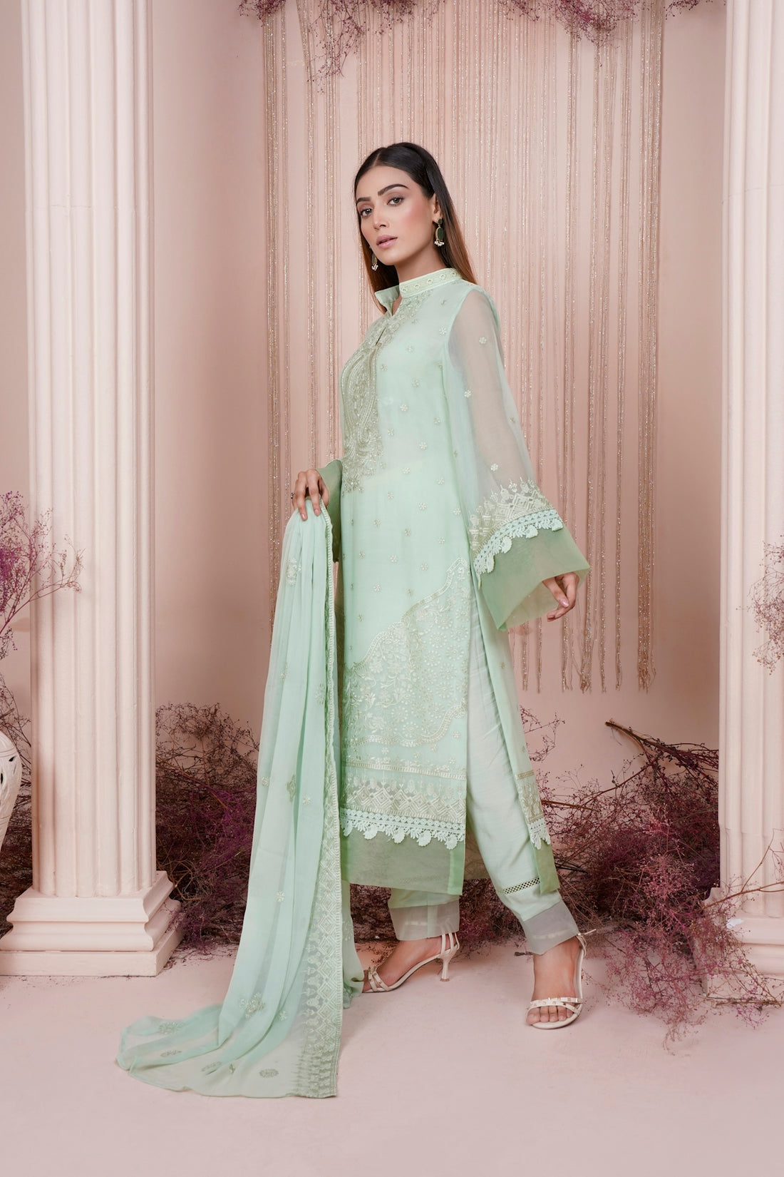 a woman in a light green salaf suit
