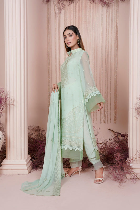 a woman in a light green salaf suit
