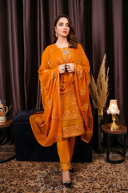a woman in an orange outfit standing in front of a curtain