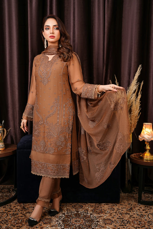 a woman standing in front of a brown curtain