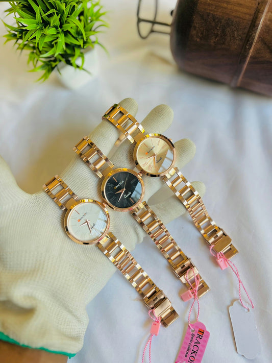 Three gold watches are presented on a white surface